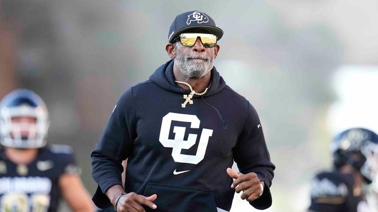 Colorado head coach Deion Sanders takes the field before an...