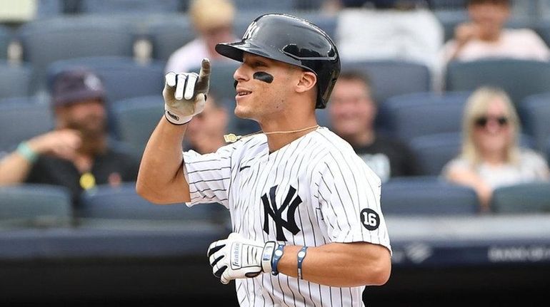 Yankees shortstop Andrew Velazquez reacts after he scored on his...