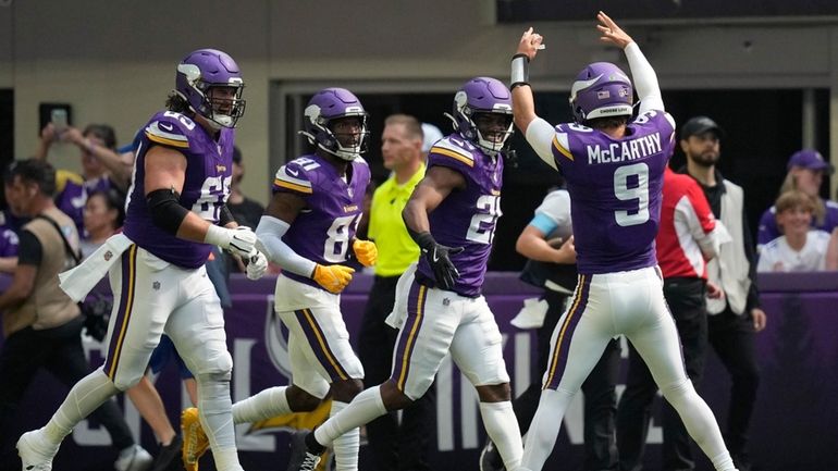 Minnesota Vikings quarterback J.J. McCarthy (9) celebrates with teammates after...