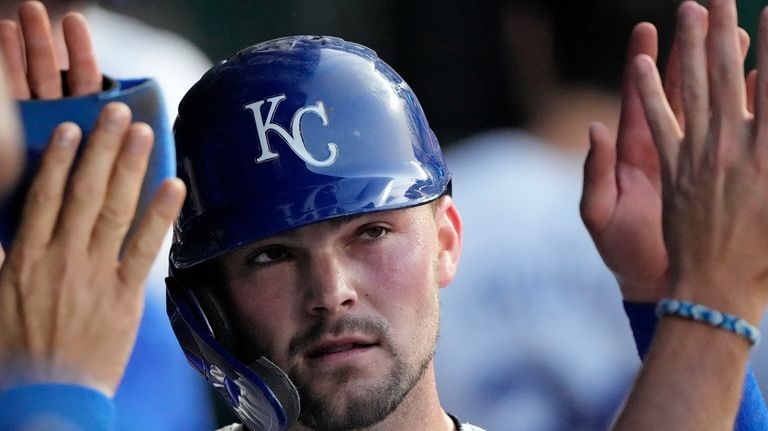 Kansas City Royals' Michael Massey celebrates in the dugout after...