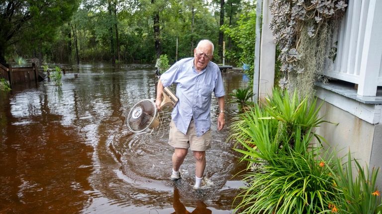 Charles Grainger cleans up around his house in the historic...