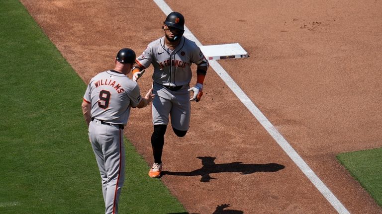 San Francisco Giants' Luis Matos, right, celebrates with third base...