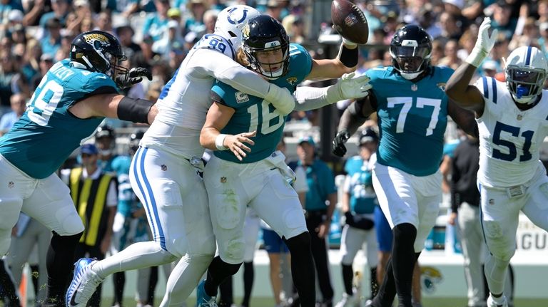 Jacksonville Jaguars quarterback Trevor Lawrence (16) is sacked by Indianapolis...