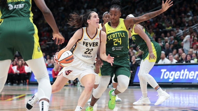Indiana Fever guard Caitlin Clark (22) drives as Seattle Storm...