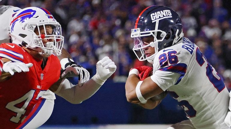 Saquon Barkley of the Giants runs the ball upfield in the first...