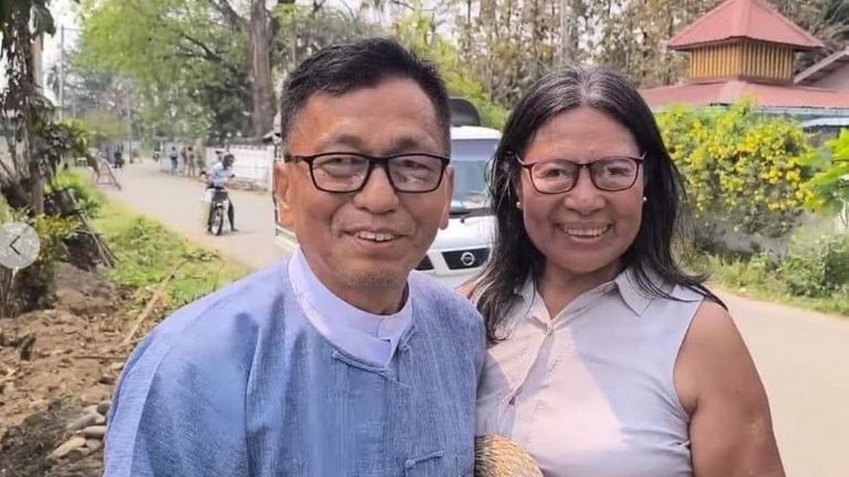 Hkalam Samson, left, poses for photography together with his wife...