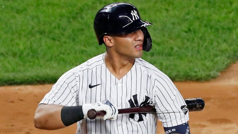 The Yankees' Gleyber Torres reacts after he struck out looking...