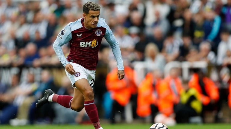 Aston Villa's Philippe Coutinho controls the ball during the English...