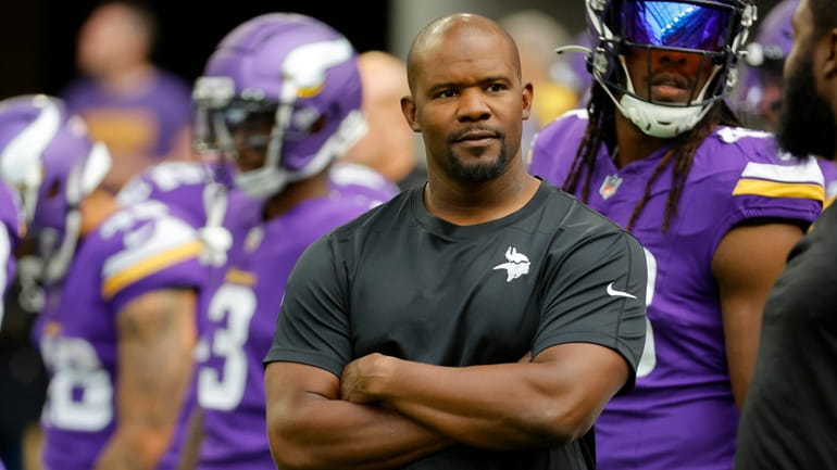 Minnesota Vikings defensive coordinator Brian Flores watches his players prior...