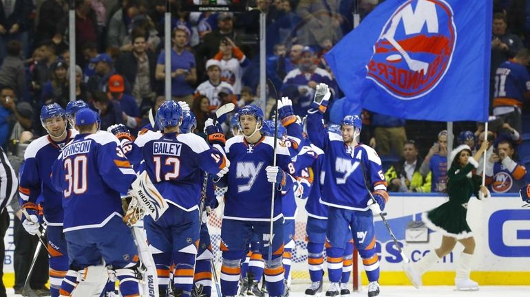 The New York Islanders celebrates after defeating the Tampa Bay...