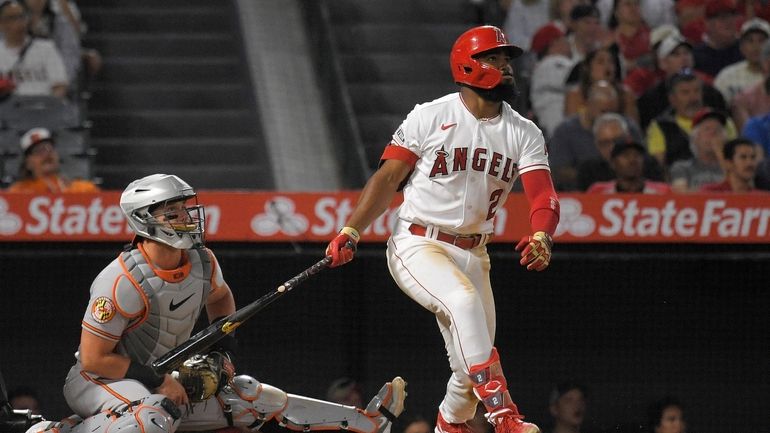 Los Angeles Angels' Luis Rengifo, right, heads to first for...