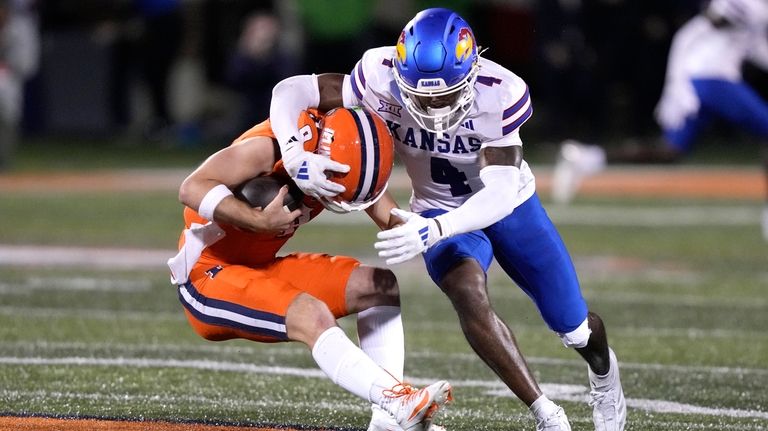 Kansas safety Marvin Grant sacks Illinois quarterback Luke Altmyer during...