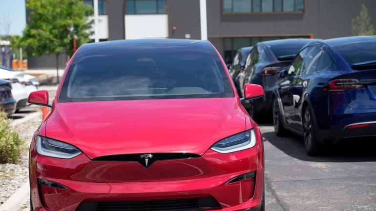 Unsold 2023 Model X sports-utility vehicles sit at a Tesla...