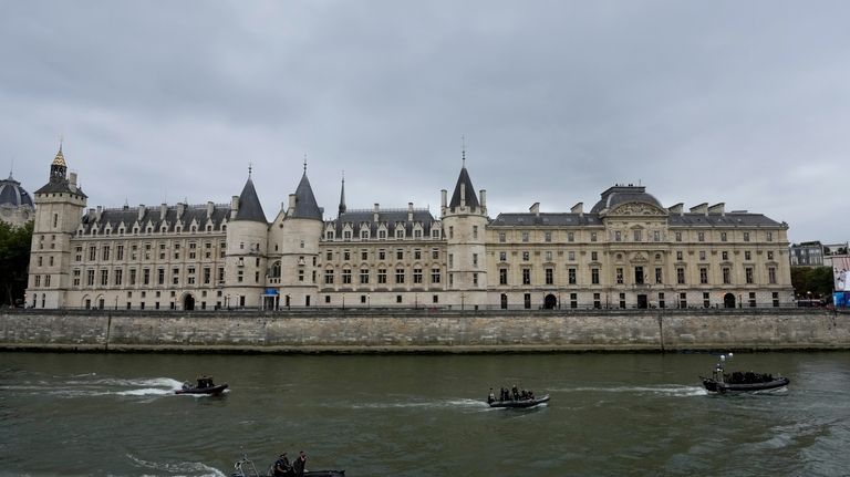 Security personnel patrol on the Seine river in front of...