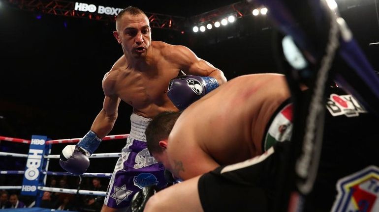 Cletus Seldin knocks down Roberto Ortiz during their Junior Welterweight...