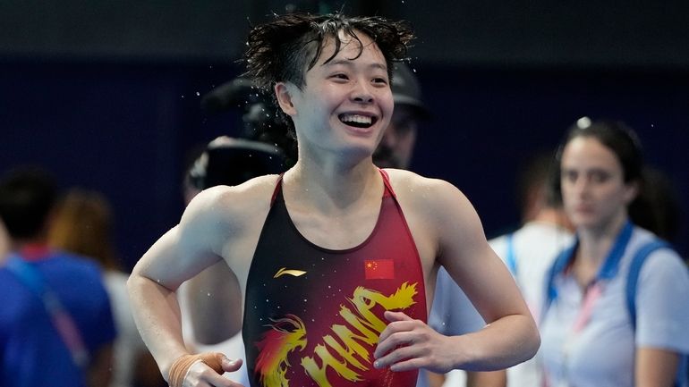 China's Chen Yiwen smiles after the women's 3m springboard diving...