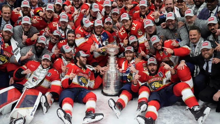 The Florida Panthers team poses with the Stanley Cup trophy...