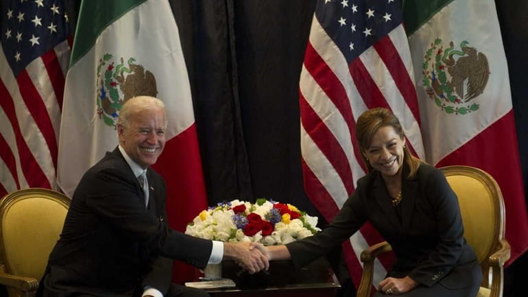 US Vice-President Joe Biden (L) shakes hands with Mexican presidential...