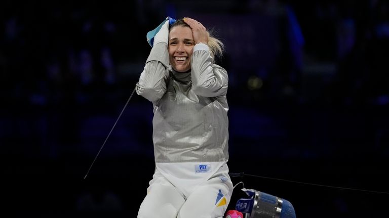 Ukraine's Olga Kharlan celebrates after winning the women's team sabre...