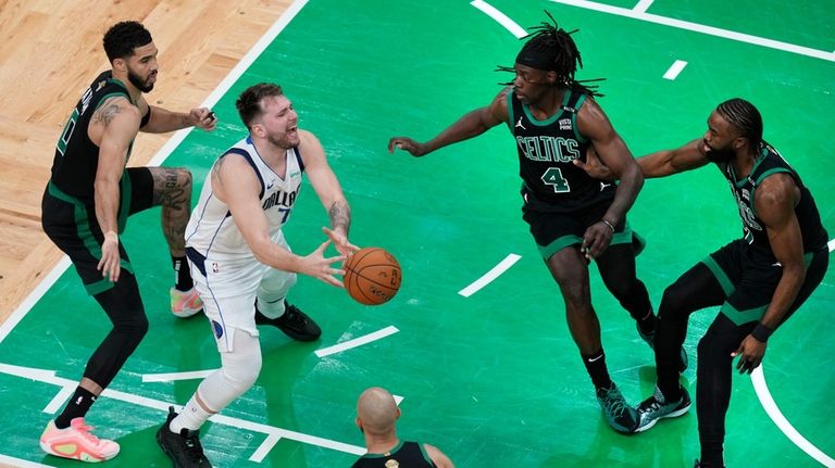 Dallas Mavericks guard Luka Doncic (77) loses control of the...