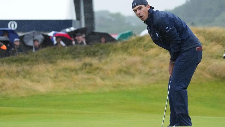 Billy Horschel of the United States reacts after missing a...