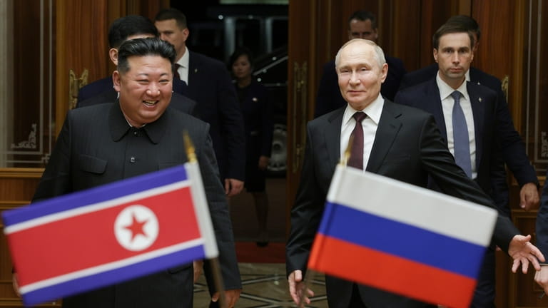 Russian President Vladimir Putin, right, and North Korea's leader Kim...
