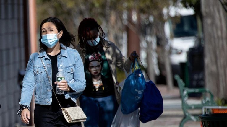 People walk down Central Avenue in Lawrence.