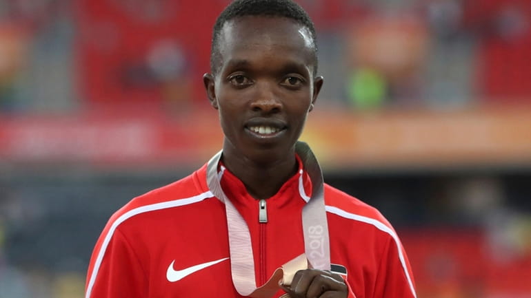 Men's 10,000m bronze medalist, Kenya's Rodgers Kwemoi on the podium...