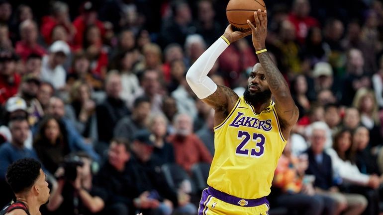 Los Angeles Lakers forward LeBron James, right, shoots over Portland...