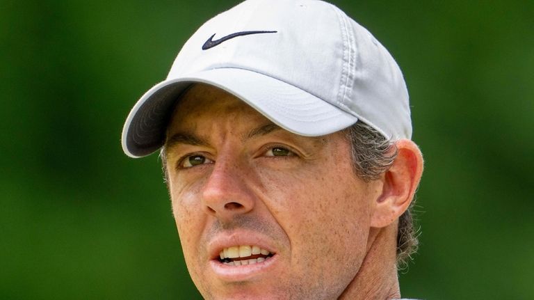 Rory McIlroy of Northern Ireland looks up at the trees...