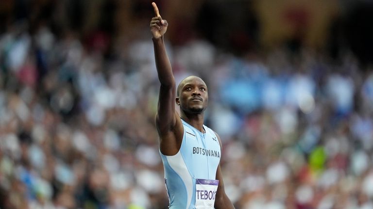 Letsile Tebogo, of Botswana, gestures after winning the gold medal...