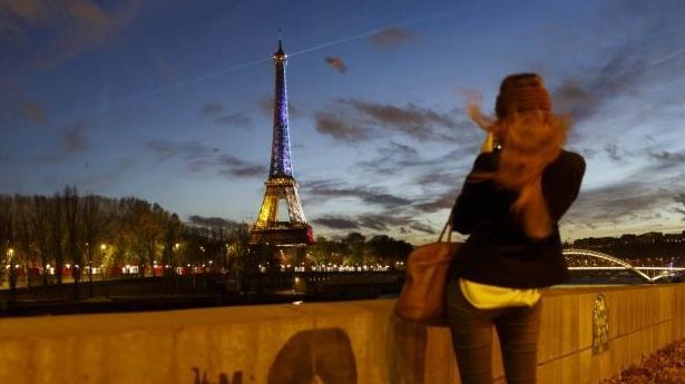 A girl takes a picture from the banks of the...