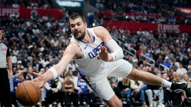 Los Angeles Clippers center Ivica Zubac jumps for a loose...