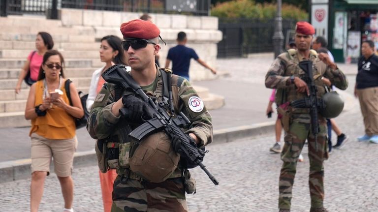 French soldiers stand guard at Sacre-Coeur of Montmartre Basilica during...