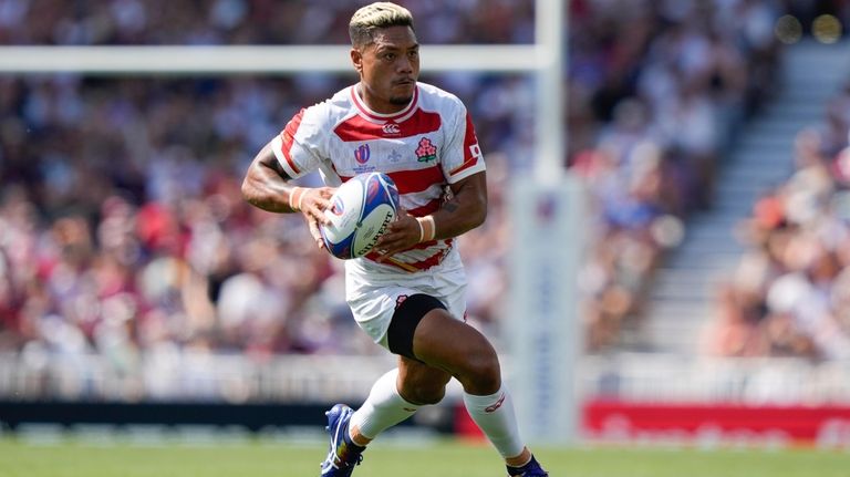 Japan's Lomano Lava Lemeki makes a run during the Rugby...