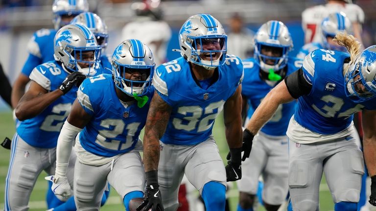 Detroit Lions safety Brian Branch (32) reacts after intercepting a...