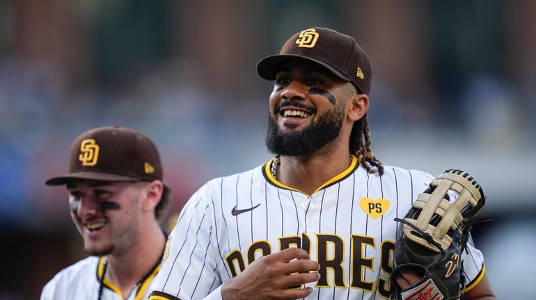 San Diego Padres right fielder Fernando Tatis Jr., right, jokes...