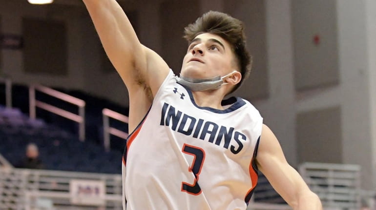 Mike Notias of Manhasset goes up for a layup and...