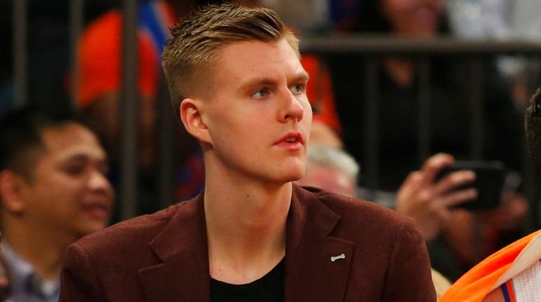 Knicks forward Kristaps Porzingis looks on from the bench during...