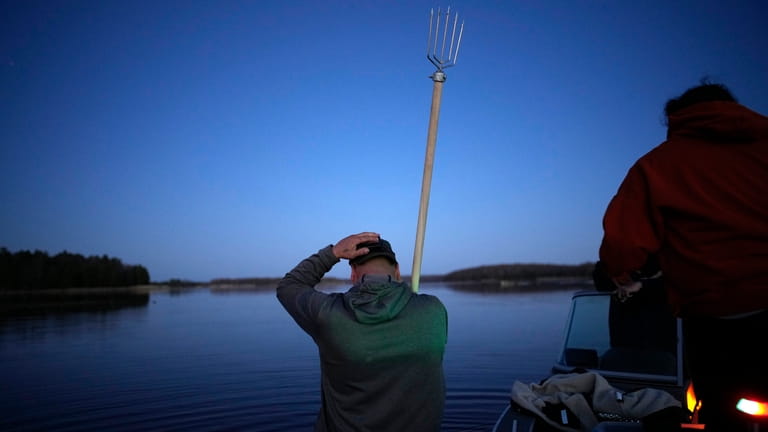 John Baker holds a spear while getting ready to fish...