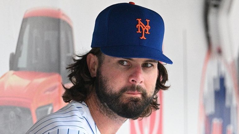 New York Mets' Jesse Winker looks on from the dugout...