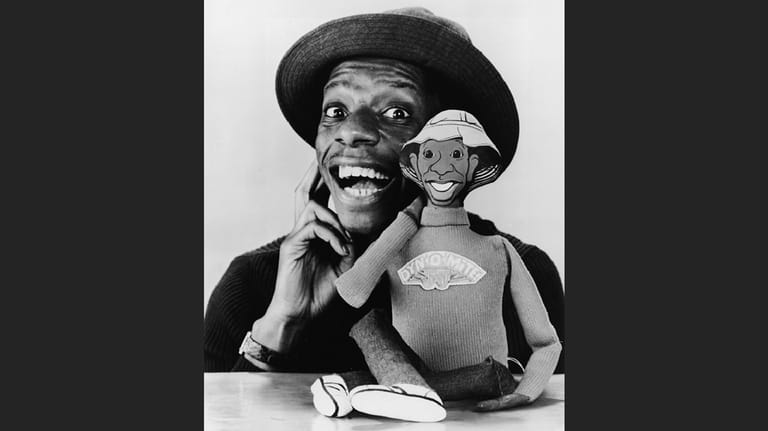 Jimmie Walker poses with a talking doll based on his...