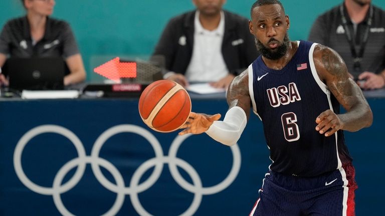 United States' LeBron James (6) passes the ball during a...