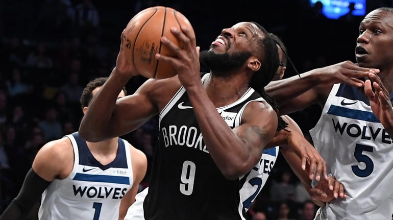 Nets forward DeMarre Carroll looks to shoot from under the...