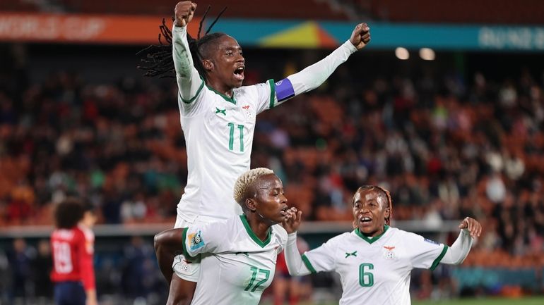 Goal scorer Zambia's Racheal Kundananji carries teammate Barbra Banda as...