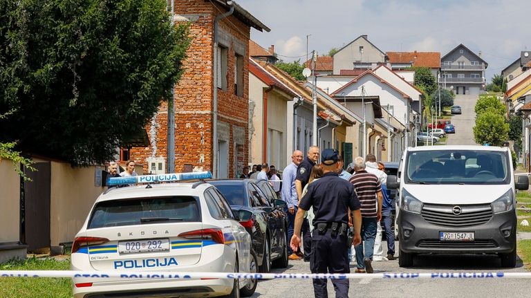 Police and forensics gather near the crime scene in Daruvar,...