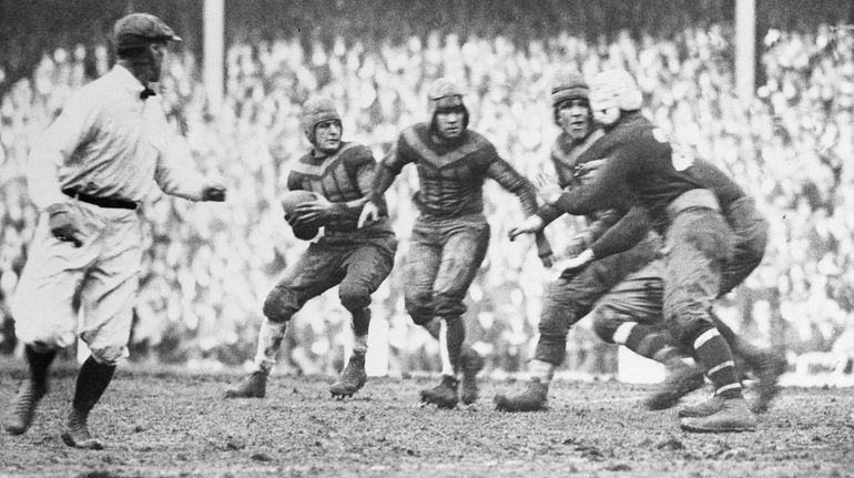 Chicago's Red Grange, left, about to make a pass against...