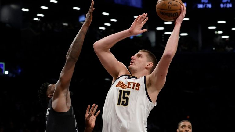 Nikola Jokic #15 of the Denver Nuggets puts up a...