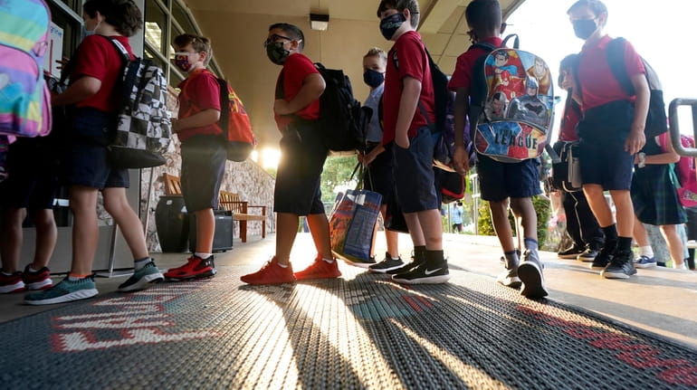 Wearing masks to prevent the spread of COVID-19, elementary school...