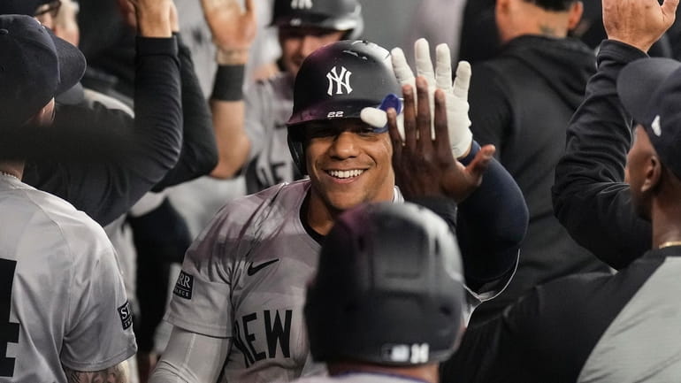 Yankees Juan Soto celebrates in the dugout after hitting a...